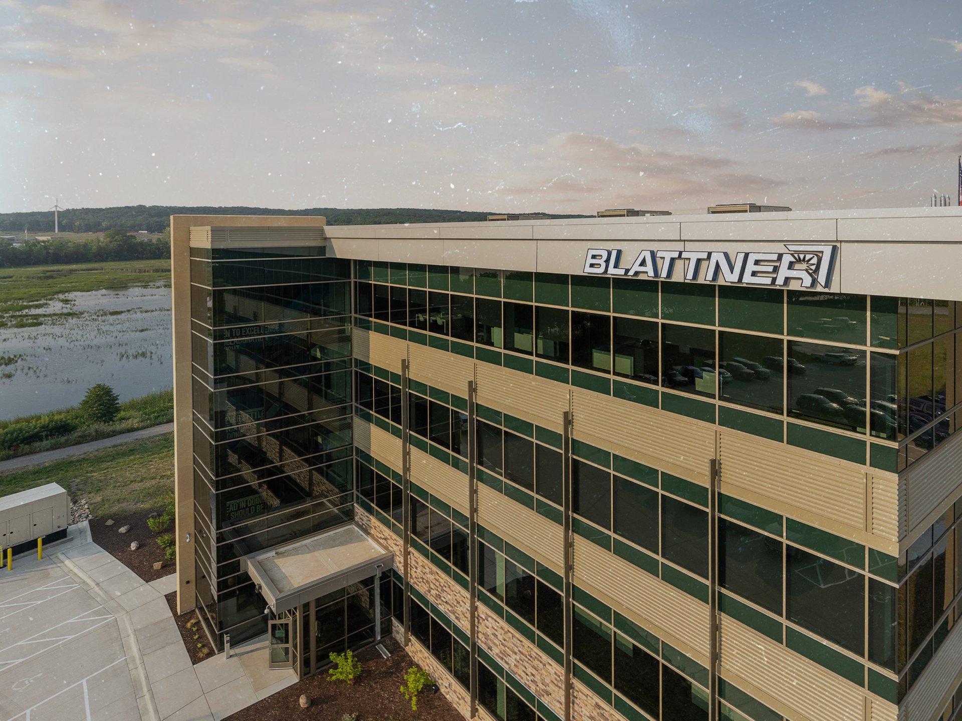 Drone image of the exterior of the Blattner corporate building with lake in the background