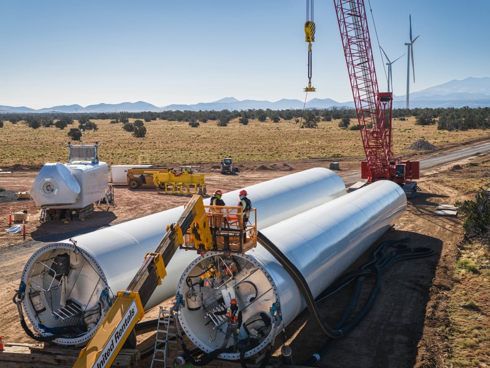 Overhead view of wind turbine towers resting on the ground before installation