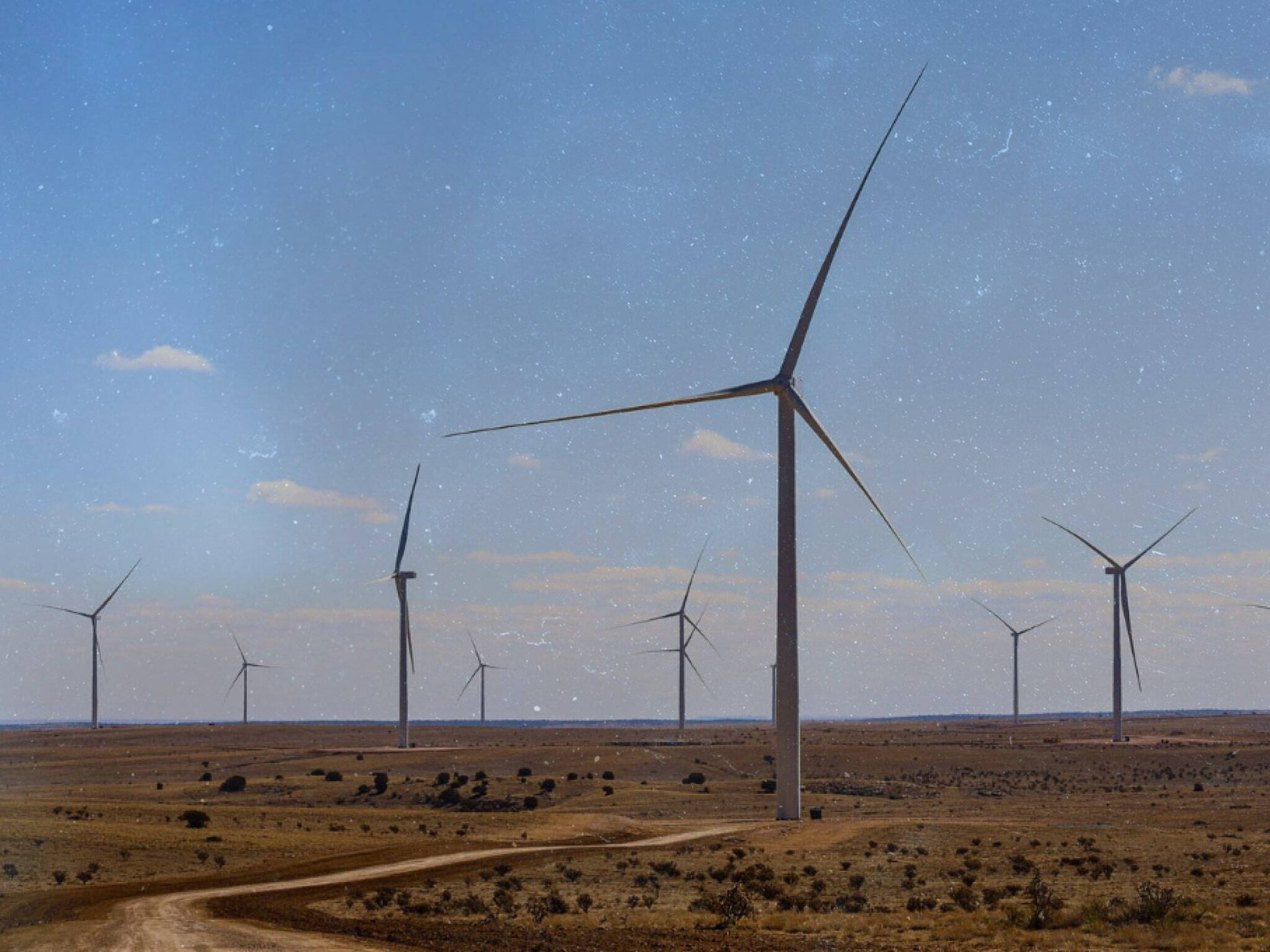 Image of collection of wind turbines on a wind farm in the high desert-min