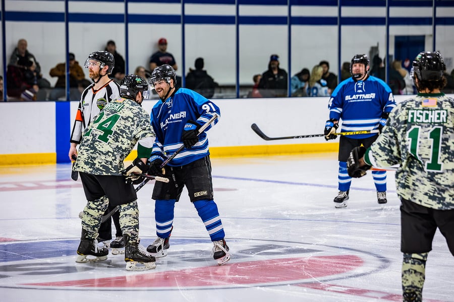 Blattner and Warrior's hockey players going face to face on the ice