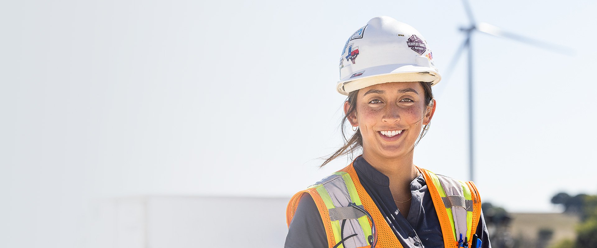 woman smiling with wind turbine