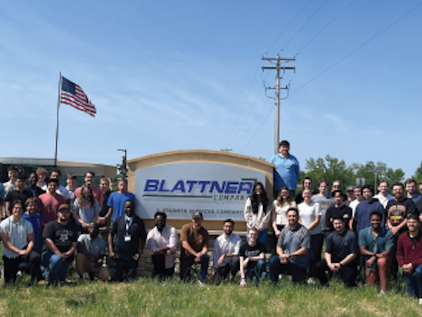 field interns in front of blattner company sign
